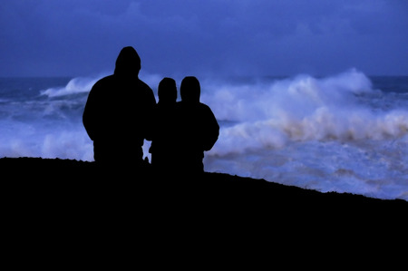 people look at dusk giant waves in sea storm in Corunna  Spainの写真素材