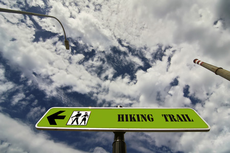 hiking trail sign with chimney and lamppost with bue sky and cloudsの写真素材