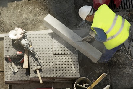 street workman repairing sidewalksの写真素材