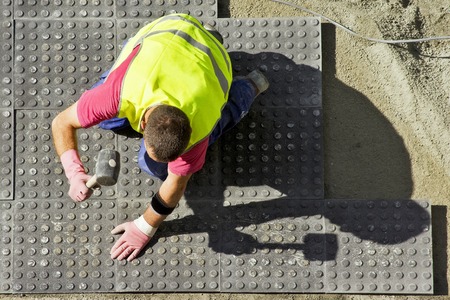 street workman repairing sidewalksの写真素材