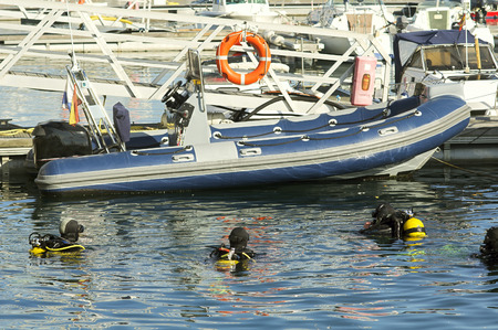 divers at sea surface at diving course with Inflatable boatの写真素材