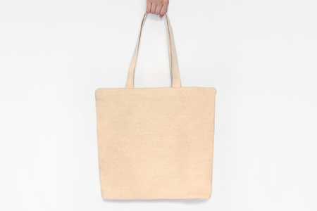 Blank canvas tote bag, design mockup with hand. Handmade shopping bags.