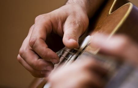 Close up on male hand playing guitar