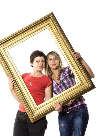 Young women posing with wooden frameの写真素材