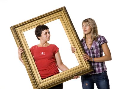 Young women posing with wooden frameの写真素材