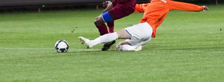 Soccer players fighting for the ballの写真素材