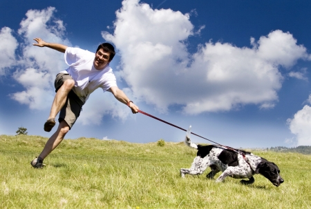 Man playing with his dog on sunny summer dayの写真素材