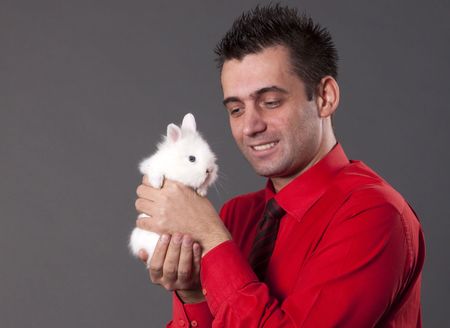 Funny man with white baby rabbitの写真素材