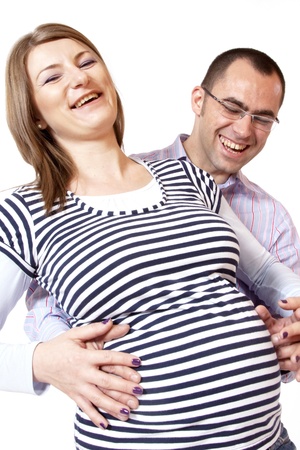 Happy young man and his pregnant wife isolated on white の写真素材