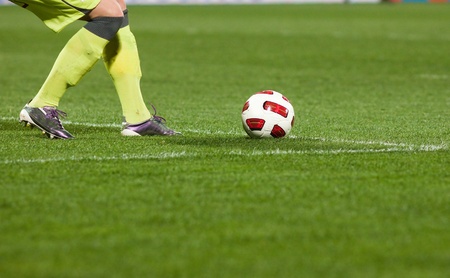 Soccer player running after the ball の写真素材