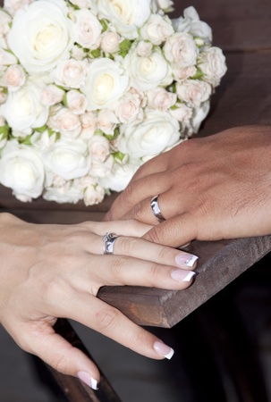 Hands and rings on wedding bouquet の写真素材