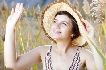 Portrait of beautiful brunette woman in summer reedの写真素材