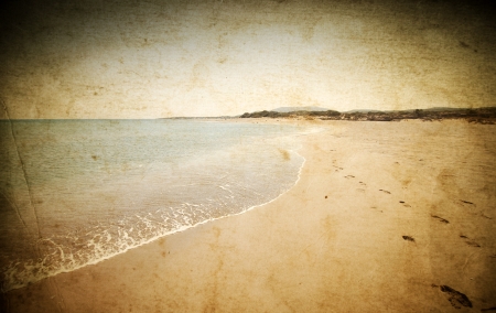 Vintage photo of beach with golden sand and blue waves の写真素材