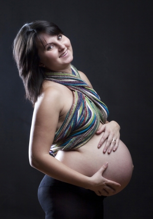 Beautiful pregnant woman on dark background の写真素材