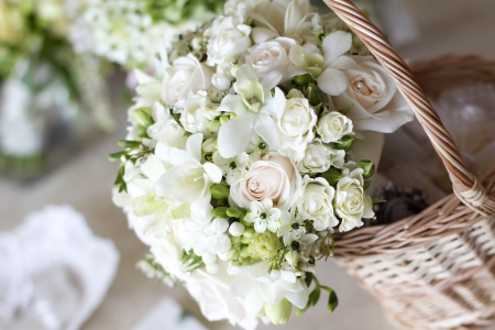 Beautiful white wedding bouquets in basket の写真素材