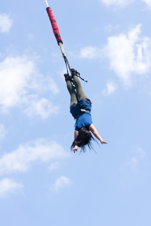 Bungee jumping - extreme sport over blue skyの写真素材