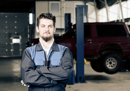 Handsome car mechanic at work