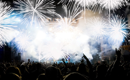 New Year concept - cheering crowd and fireworksの写真素材