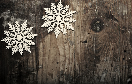 Snowflakes on grunge wooden background. Winter holidays conceptの写真素材