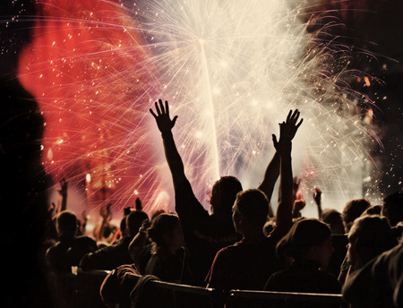 New Year concept - cheering crowd and fireworksの写真素材