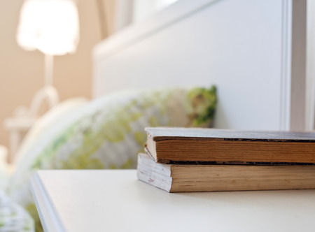 bedroom with books on nightstandの写真素材