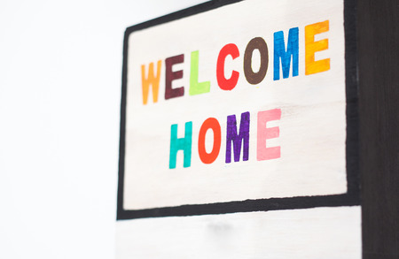 WELCOME HOME sign on wood - colorful lettersの写真素材