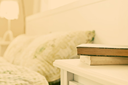 bedroom with books on nightstandの写真素材
