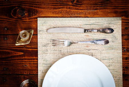Table setting for two with empty plates - rustic wooden tableの写真素材