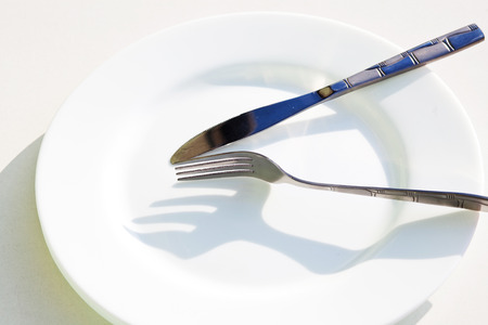 Knife white plate and forkの写真素材