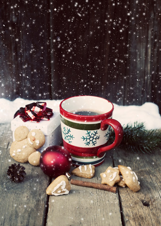 Mulled wine, gingerbread and Christmas decorations on vintage wooden tableの写真素材