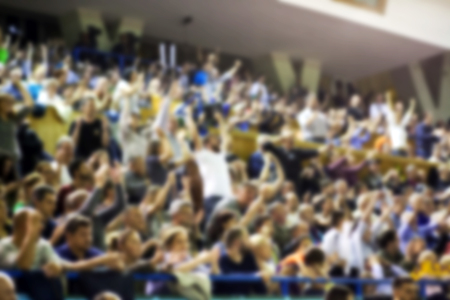 Blurred background of crowd of people in a basketball courtの写真素材