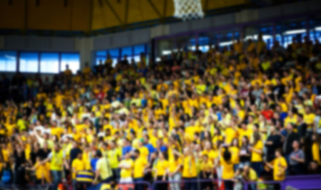 Blurred background of crowd of people in a basketball courtの写真素材
