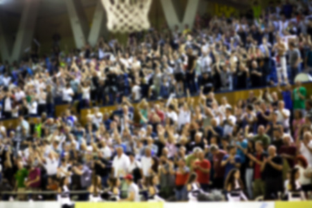 Blurred background of crowd of people in a basketball courtの写真素材