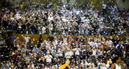 Blurred background of crowd of people in a basketball court
