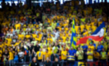 Blurred background of crowd of people in a basketball courtの写真素材