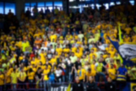 Blurred background of crowd of people in a basketball courtの写真素材