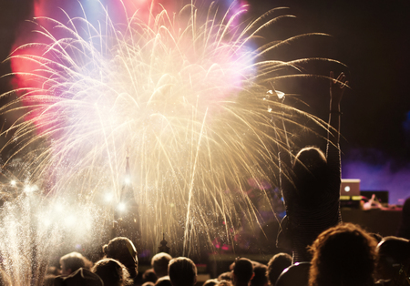 New Year concept - cheering crowd and fireworksの写真素材