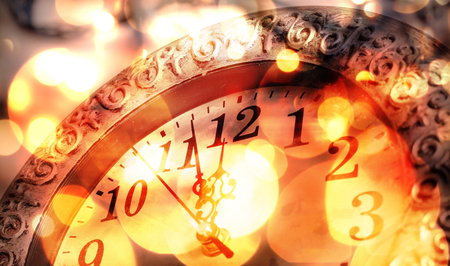 old clock with fireworks and holiday lights - New Year's at midnight