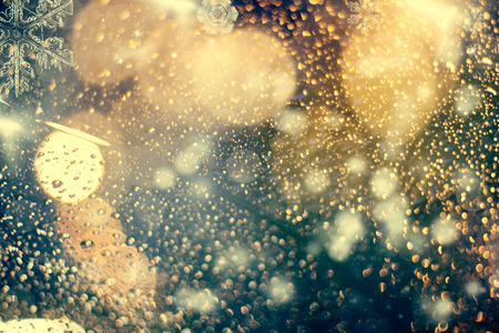 abstract Christmas background with holiday lights and copy space - magic bokeh glitter with blinking stars and falling snowflakesの写真素材