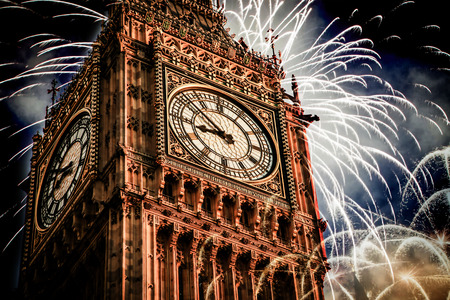 Explosive fireworks display fills the sky around Big Ben. New Year's Eve celebration background