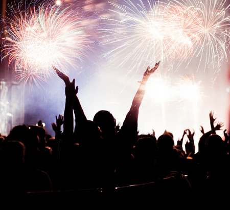 cheering crowd watching fireworks at New Year - holiday celebration backgroundの写真素材