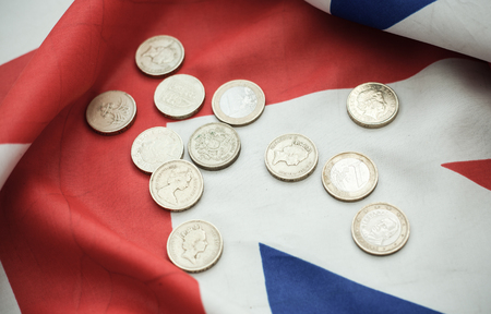 one pound coins on British flagの写真素材