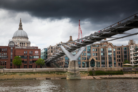 LONDON/UK - MAY 20 : Pedestrians crossing Millenium Bridge, London. View from the riverのeditorial素材
