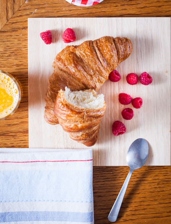 delicious continental breakfast of orange juice and croissantsの写真素材