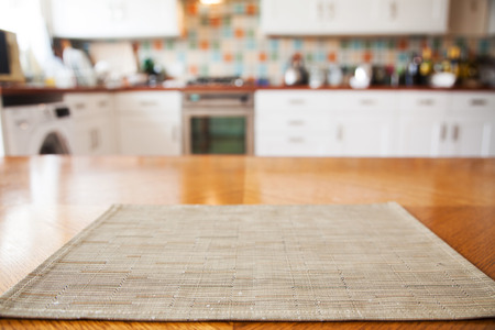 blurred kitchen interior and napkin and desk spaceの写真素材