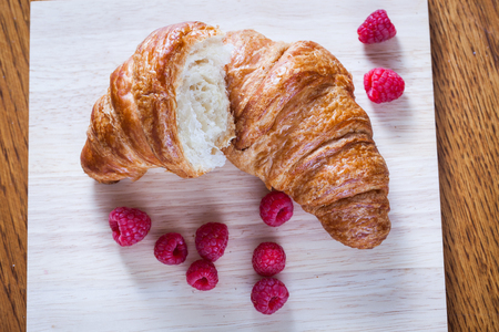 delicious continental breakfast of orange juice and croissantsの写真素材