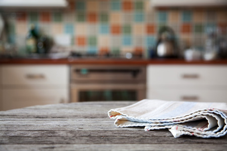 blurred kitchen interior and napkin and desk spaceの写真素材