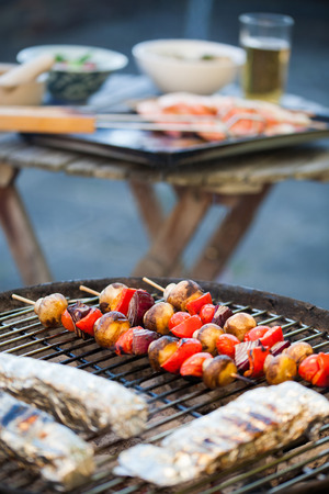 barbecue in the garden - summer- prawns and vegetables on skewersの写真素材