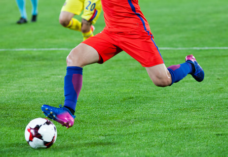 soccer player kicking the ball - blurred backgroundの写真素材