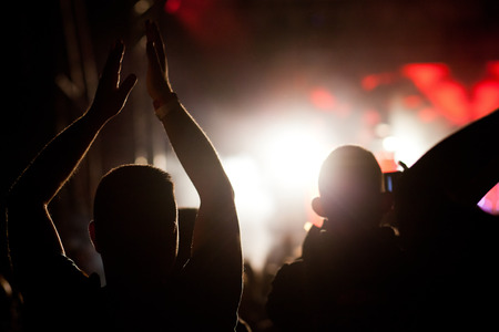 crowd with raised hands at concert - summer music festivalの写真素材